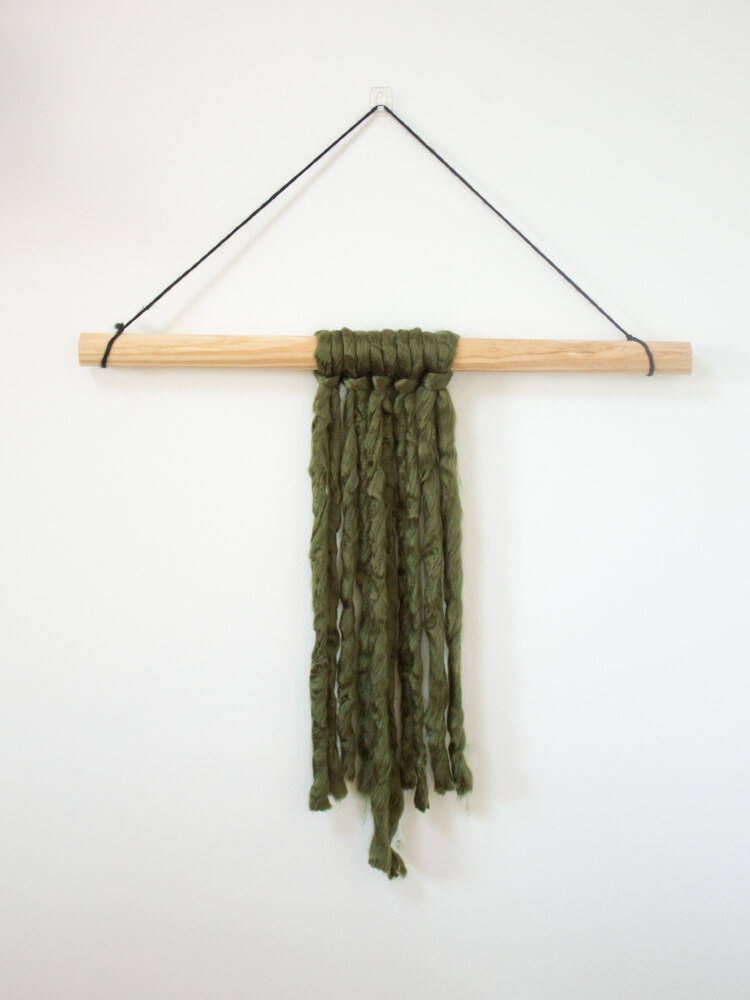 If you're looking for a quick and easy way to fill a blank space on your wall and make a statement, this modern DIY yarn wall hanging is perfect! It's so simple and only takes about 20 minutes start to finish! 