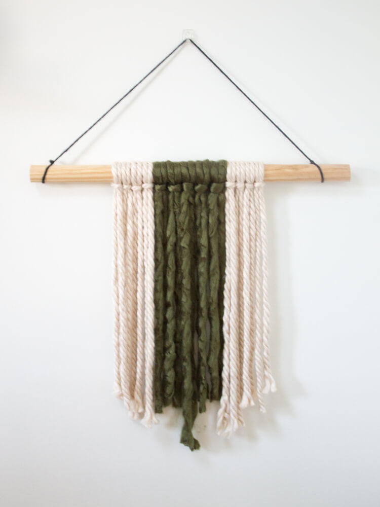 If you're looking for a quick and easy way to fill a blank space on your wall and make a statement, this modern DIY yarn wall hanging is perfect! It's so simple and only takes about 20 minutes start to finish! 