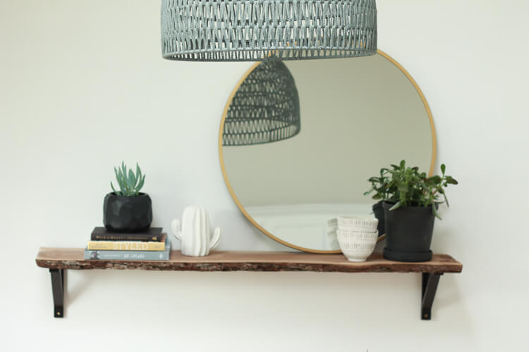 A modern minimal shelf design using plants and a round mirror. How to Decorate Shelves: Follow these simple guidelines for styling open shelving in your home | My Breezy Room