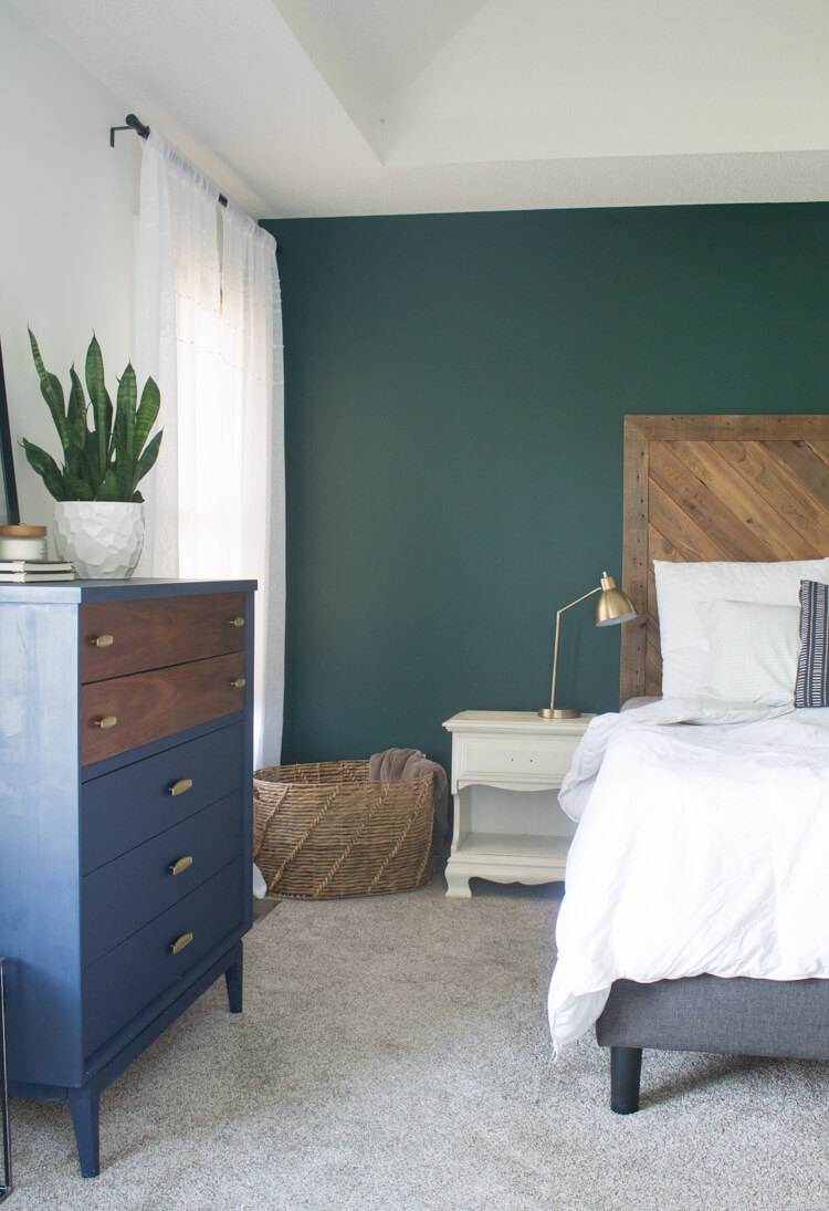 How to decorate your bedroom for better sleep: Dark calming wall colors like this dark green help us relax for a better nights sleep. 