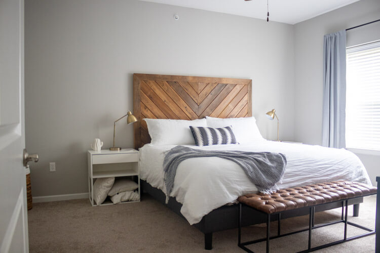 Mix materials to add texture to your home. This room mixes a wooden headboard, linen duvet and a leather bench to make a cozy bedroom. 