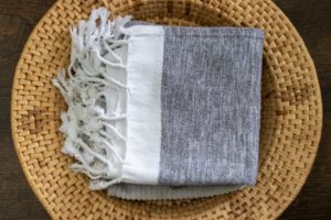 pile of turkish towels in basket - ditch the paper towels and use washable towels